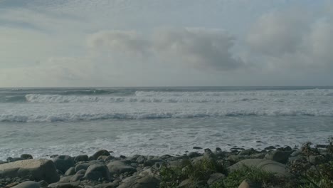 Waves-coming-towards-the-camera-on-a-rocky-beach-in-south-of-Portugal