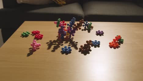 coloured interlocking shape puzzle on table at home for child diagnosed with asd 5