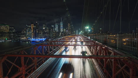 traffic cars over the brooklyn bridge against the backdrop of the silhouette of the night in new yor