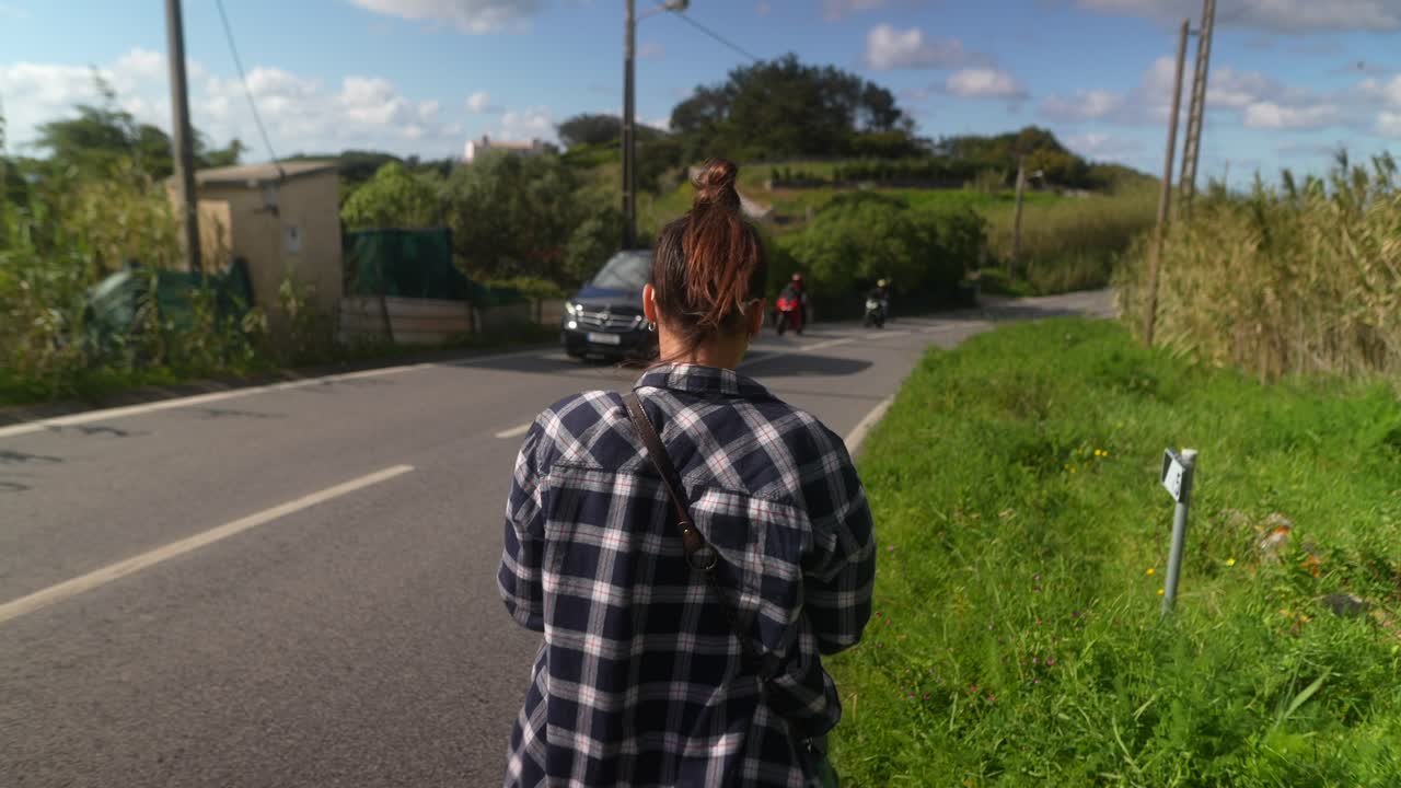Woman Walking Along a Country Road