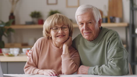 Portrait-of-Cheerful-Elderly-Couple-at-Home