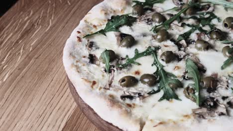 appetizing pizza on a wooden table in a restaurant