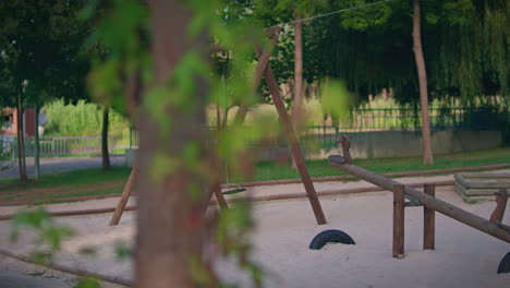 childrens playground without people wooden swing slow motion long shot