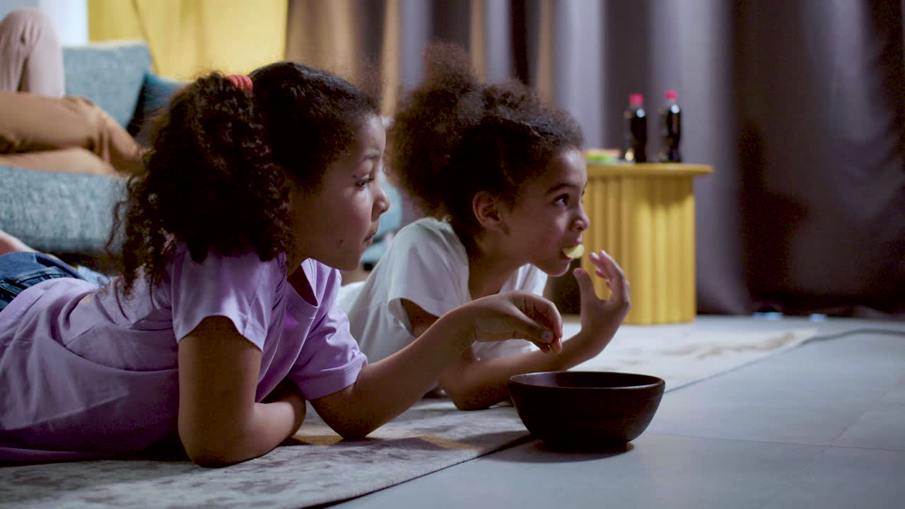 Kids watching film at home