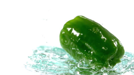 green pepper falling on water