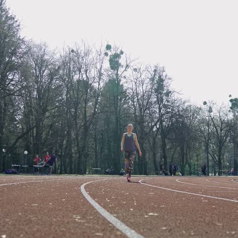 track runner athlete woman warming up before running at a stadium. sport. healthy fitness lifestyle.