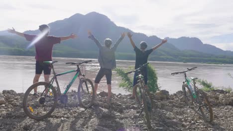 friends celebrating a bike ride by the river
