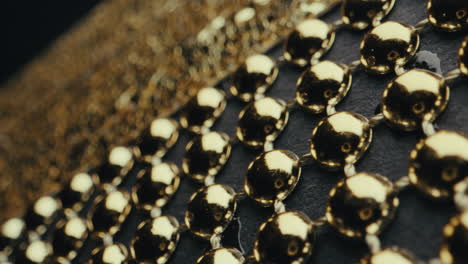 close-up of gold glitter and bead trim
