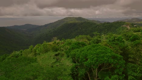 Aerial-of-a-dimly-lit-rainforest-and-a-far-off-mountain-in-Costa-Rica