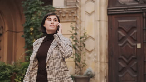 caucasian businesswoman using smartphone outdoor.