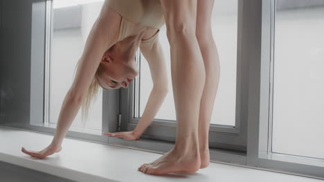 woman stretching by window