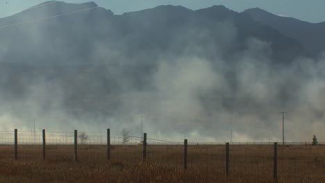 fire distant with car driving trough