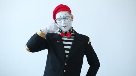 mime making a phone gesture