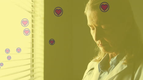 heart icons floating around woman looking out window with animation effect