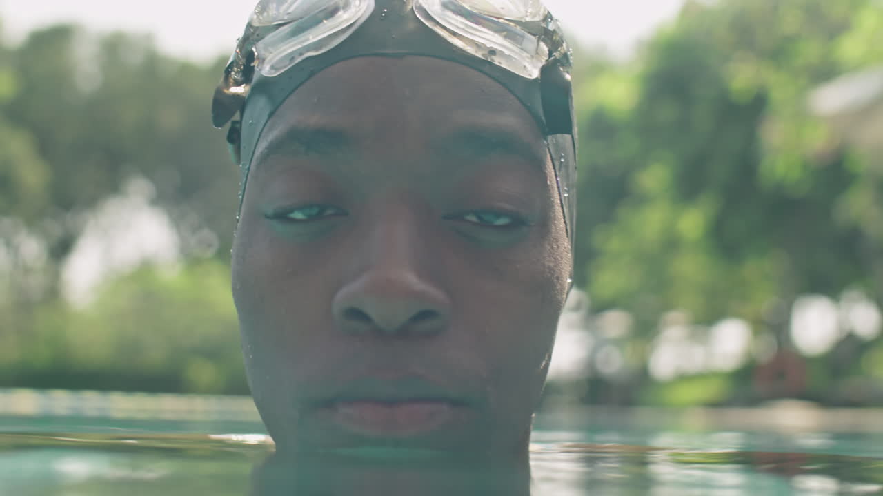 Portrait of Professional Black Swimmer in Pool Water