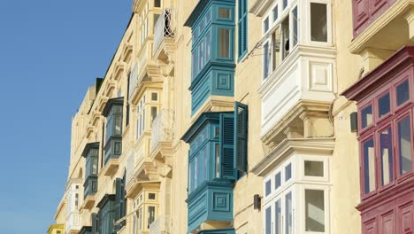 Colourful windows and shutters on limestone buildings in Valetta, Malta