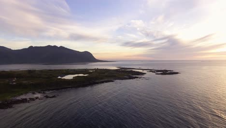 Aerial-of-a-shore-at-sunset-on-Lofoten,-Norway