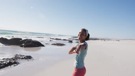 African-american-couple-on-the-beach,-man-running-after-woman