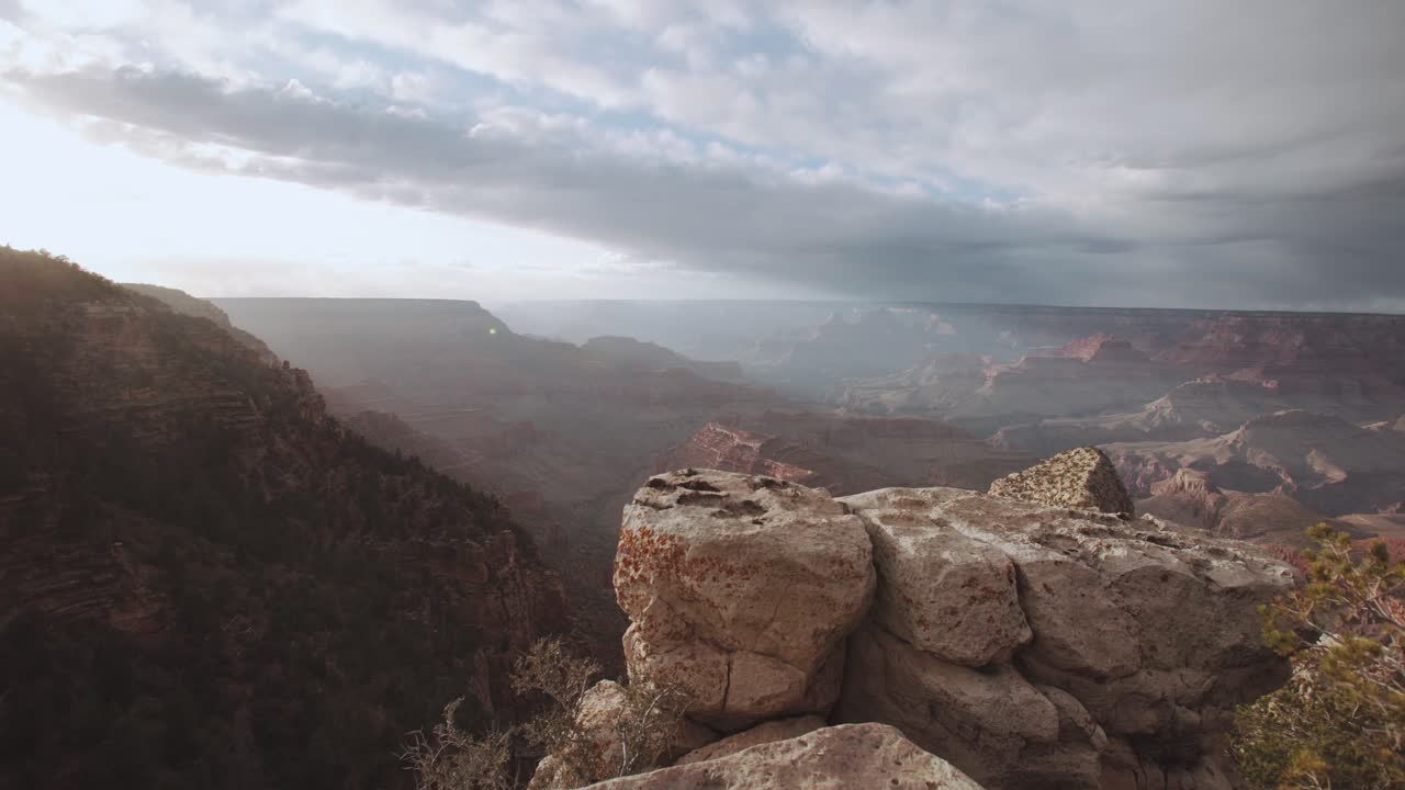 Grand Canyon cliff edge looking out over sunset, reveals the valley below - Gimbal - Arizona USA