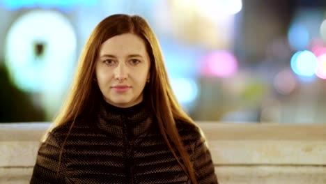 retrato de una mujer joven en una gran ciudad por la noche.