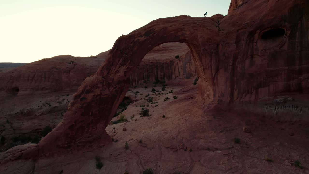Rekaman drone terbang melewati Corona Arch di Moab, Utah saat matahari terbenam