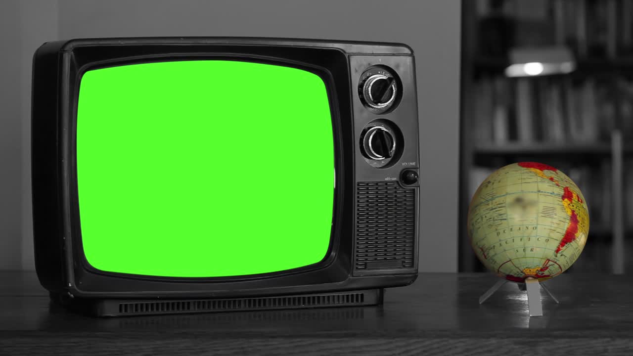 Vintage Television with Green Chroma Screen near a Spinning Globe Map. 4K Resolution.