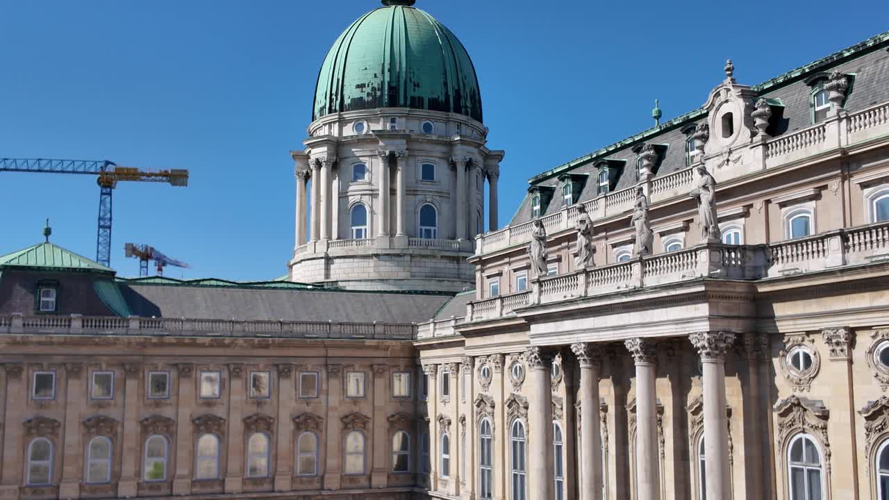Architectural detail of Buda Castle with statues and columns on a sunny day with clear blue sky