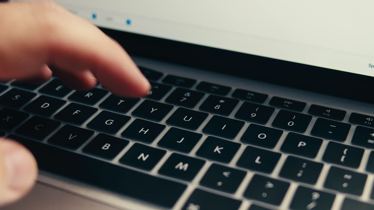 Close-up of Hand Typing on Laptop Keyboard