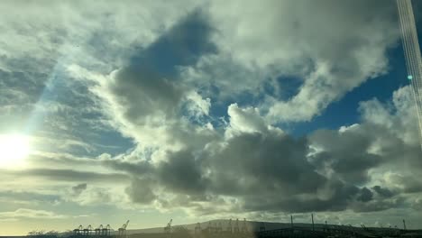 beautiful cumulus clouds rolling over the port of long beach, california