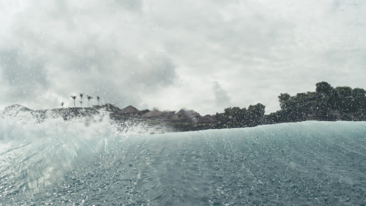 Tropical coastline and sunlit ocean surface sparkle with soft mist and motion