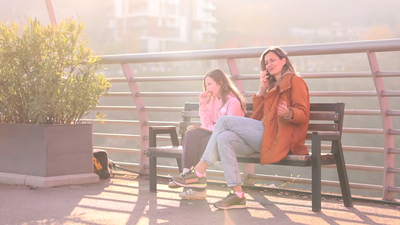 Mother and Daughter Chatting on Bench