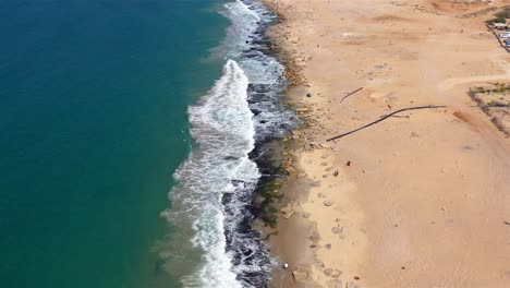 aerial view of a beach with waves and people