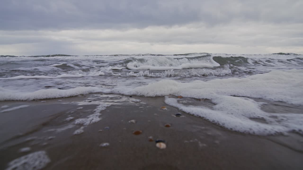 Waves gently crashing on a beach at Domburg, Zeeland, Netherlands in super slow motion