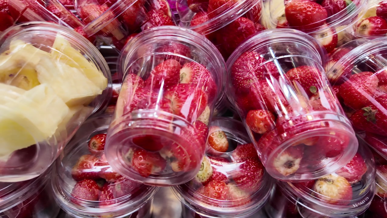 Fresh Strawberries and Pineapple Chunks in Plastic Cups