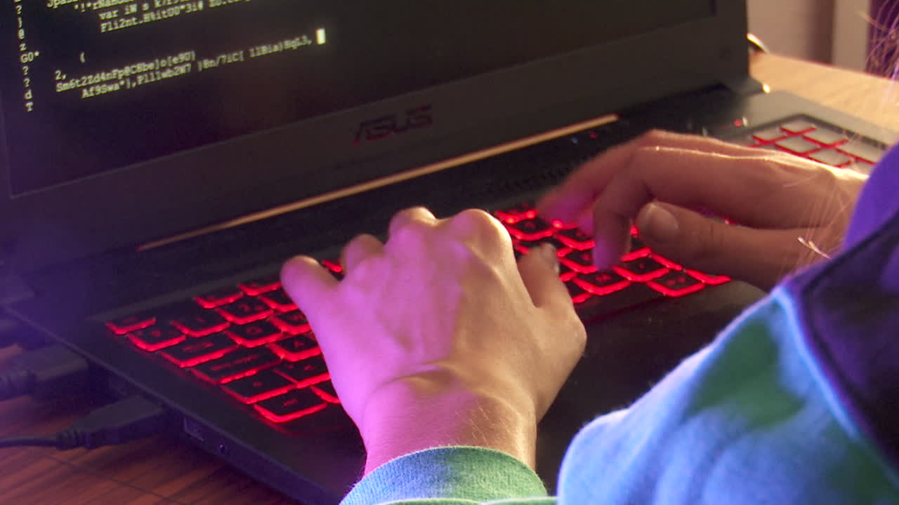 Person Coding on Laptop