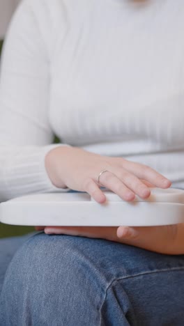 close-up of hands holding a white tray