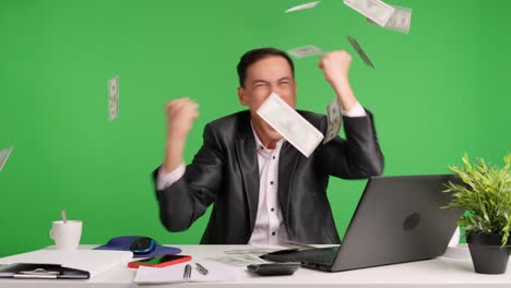 Successful businessman throwing money on green screen background