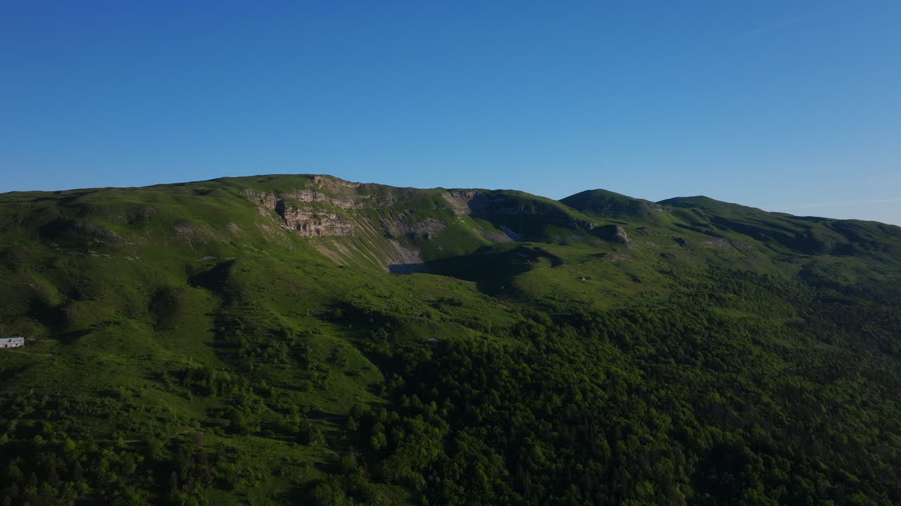Aerial sunrise over Lake Geneva with fiery orange and red skies, panoramic Alpine views, and tranquil morning reflections on Lac Léman from the Jura.