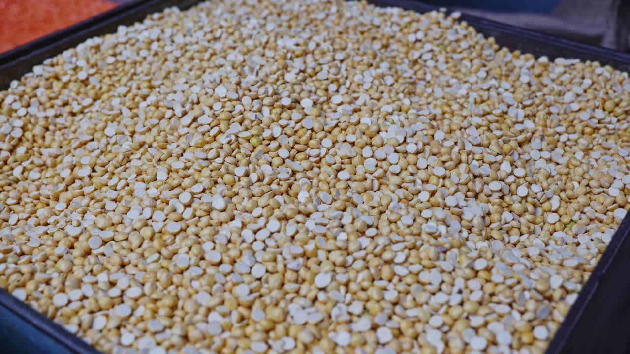 roasted chana dal or putana in grain storage box, stable shot, 4k.