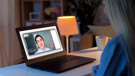 woman having video call on laptop at home