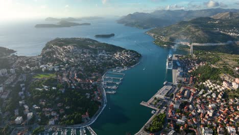 aerial of dubrovnik, its marina, and surrounding adriatic coastline in croatia. slow pan left, bird's eye view, from above