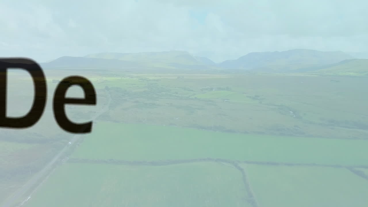 Development text animation over aerial view of green fields and mountains