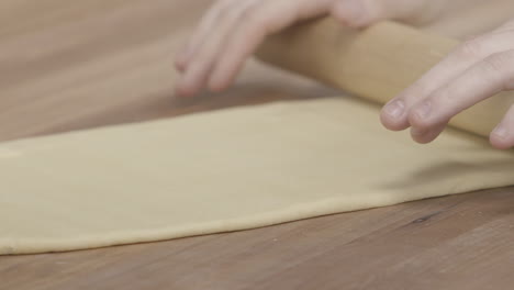 closeup slow motion of a master chef rolling pasta by hand