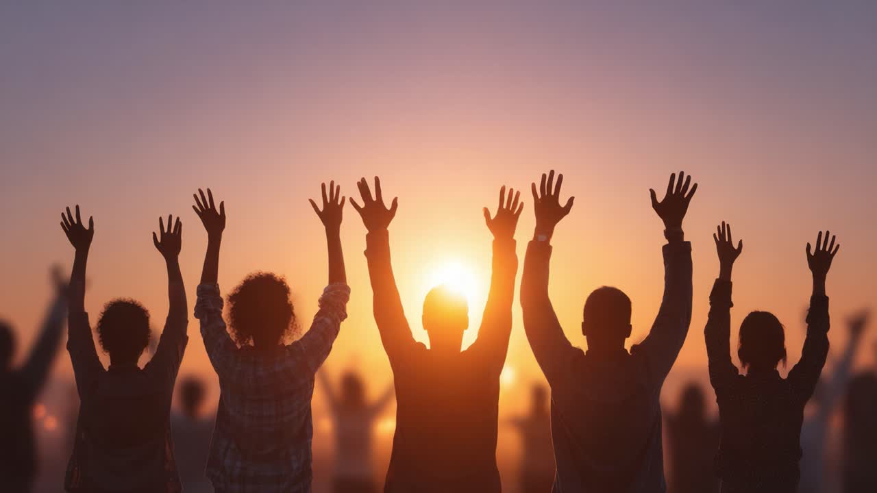 Celebration at Dusk: A Group of Individuals Joyfully Raising Their Hands Against a Vibrant Sunset, Signifying Unity, Hope, and Positive Energy