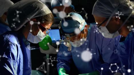 Animation-of-molecules-over-group-of-diverse-male-and-female-surgeons-at-surgery-room