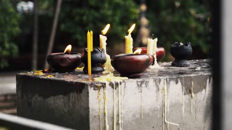 candles burning outside of ancient temple