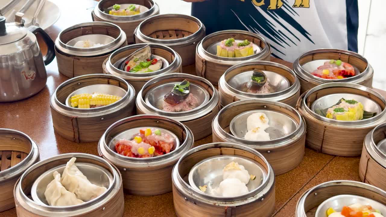 Multiple dim sum baskets arranged and served on a table in bright natural lighting