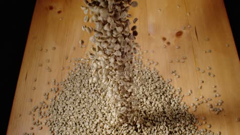 coffee beans fall onto a table