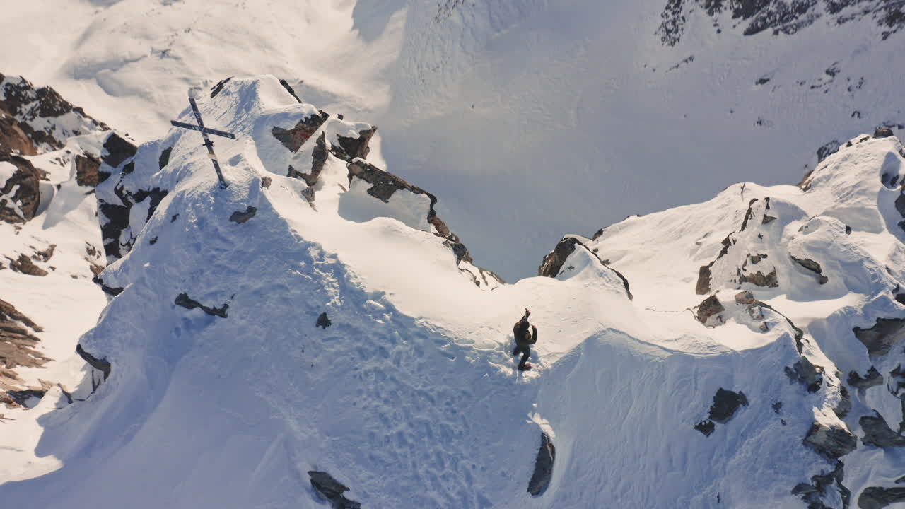 Beautiful Cinematic Aerial View of talented Artist Playing Violin on Top of Snowy Mountain in the Italian Alps.
Flying over Mountain Peak with Violinist Playing Music Instrument Top Down Camera.