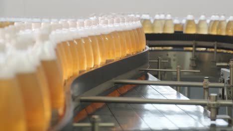 conveyor belt with bottles for juice or water at a modern beverage plant. modern production of sweet soda water